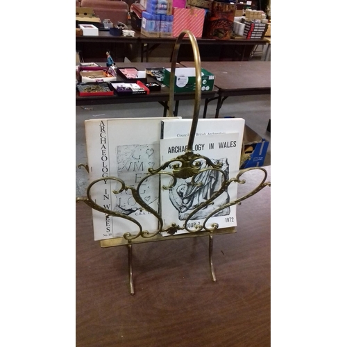 64 - Solid brass shell basket magazine rack with assorted archaeology magazines