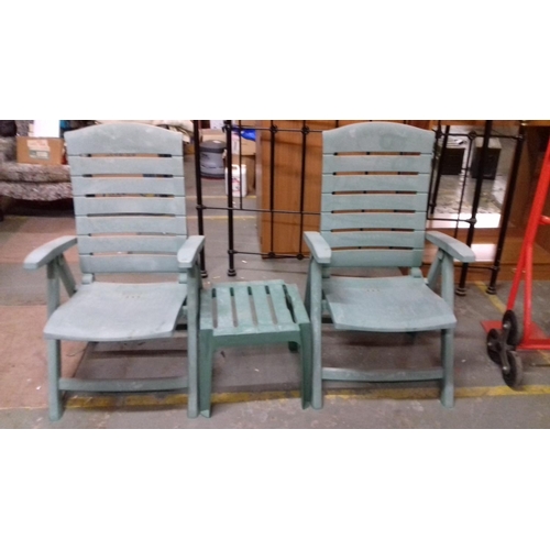 508 - Pair of weathered green plastic garden loungers and side table