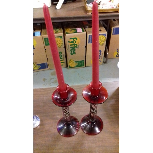 116 - Pair of red swirl art glass candle sticks with red candles 25 cm tall