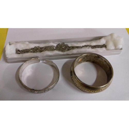 39 - Ornate white metal bracelet and 2 x white metal bangles, 1 with chinese stamp