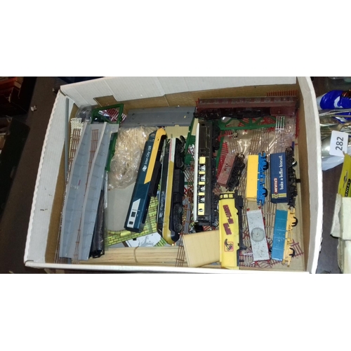 284 - 2 x boxes of assorted double o gauge trains, coaches, rolling stock and other accessories and spare ... 