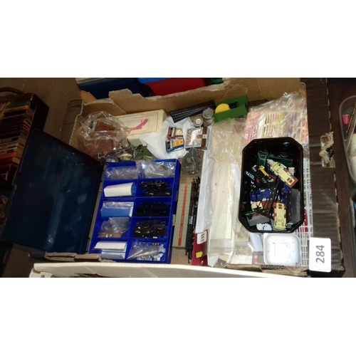 284 - 2 x boxes of assorted double o gauge trains, coaches, rolling stock and other accessories and spare ... 