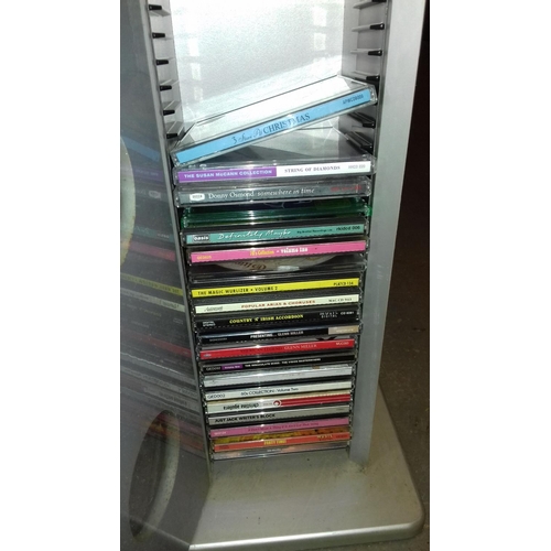 271 - Tower cd rack with door front and quantity of assorted cds