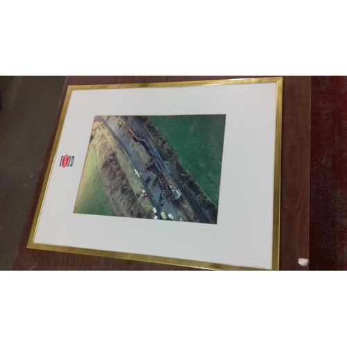 517 - 56 x 52 cm & 65 x 51 cm gilt framed aerial derailment photographs removed from Jarvis Rail head offi... 