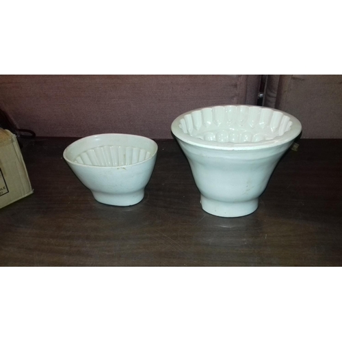 136 - 2 x Victorian ceramic blancmange moulds, largest being copeland with prince of wales feathers top