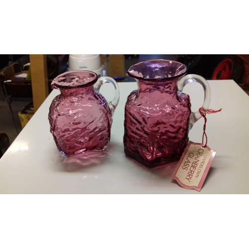 41 - 2 x hand blown cranberry glass jugs being 12 and 10 cm tall