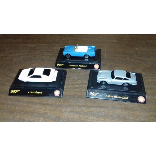 85 - 3 x Shell 007 series die cast cars on plastic base being Lotus, Aston Martin and Sunbeam