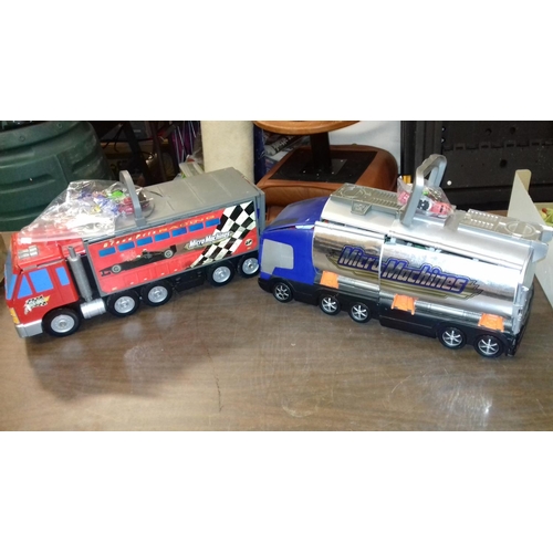 235 - 2 x micro machine transporter play lorries with some vehicles