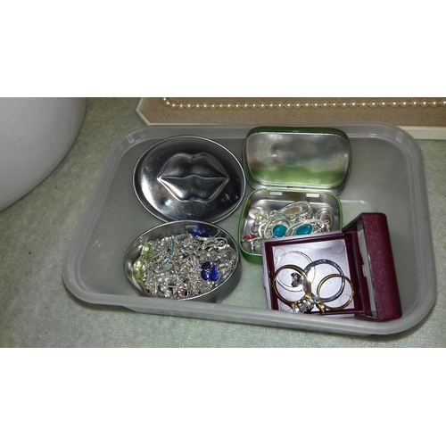 28 - Tub of assorted silver coloured fashion earrings and 4 x dress rings