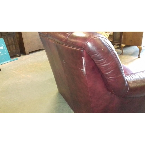 435 - Oxblood red faux leather 2 seater couch, scuffing on the rear corner