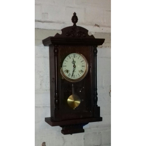 9 - 31 day mechanical wall clock with pendulum and key present