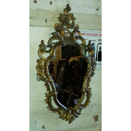 11 - Small gilt ornate plastic framed decorative wall mirror approx. 60 x 34 cm