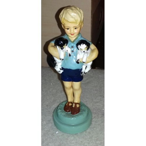 70 - 20 cm tall Worcester model of boy holding two puppies