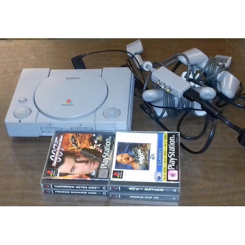 386 - PlayStation 1 gaming console, two controllers and 4 games