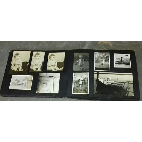 94 - Vintage photo album with assorted black and white family portrait and holiday photographs etc.