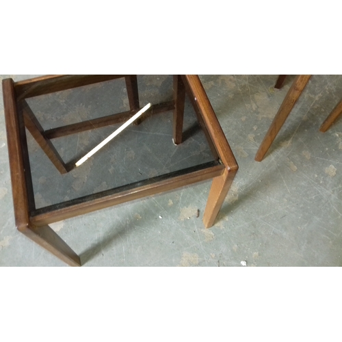 372 - Retro teak and smoked glass nest of tables (middle and smaller with nicks to glass)