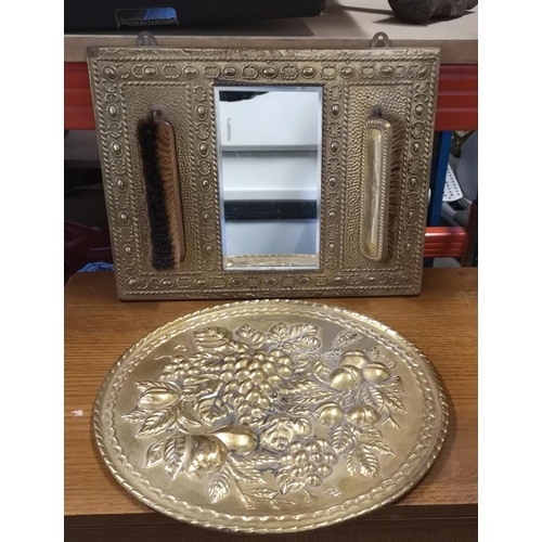 211 - 39 x 30 cm embossed brass mirror with brushes & 36.5 cm diameter embossed wall plate with fruit