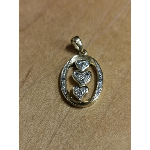 45 - 2 cm long oval triple heart locket, unstamped yellow metal with illusion diamonds