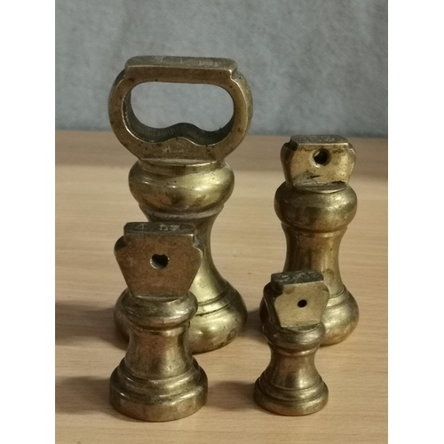 87 - Set of brass kitchen scale weights being 8/4/2/1 oz