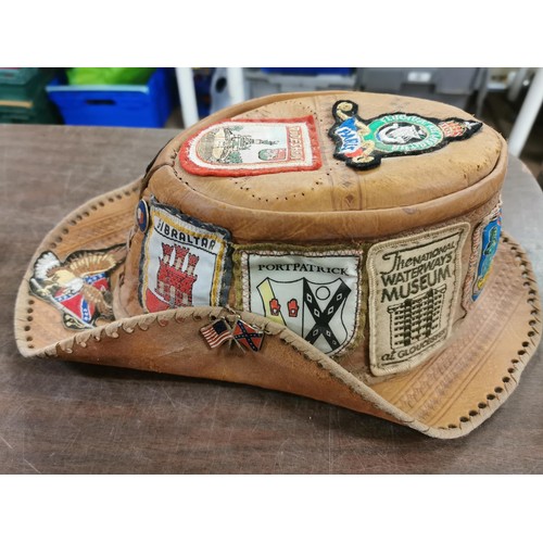 257 - Genuine Australian leather bushtucker hat with assorted material and metal badges attached