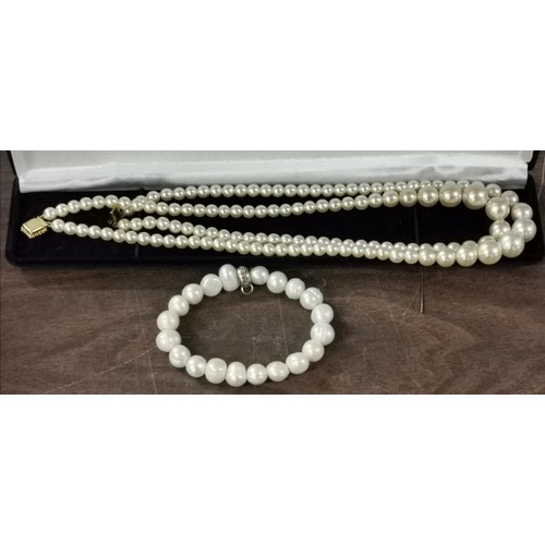 169 - Simulated 2 string pearl necklace with gold tone clasp and similar 'charmed by devil' elasticated br... 