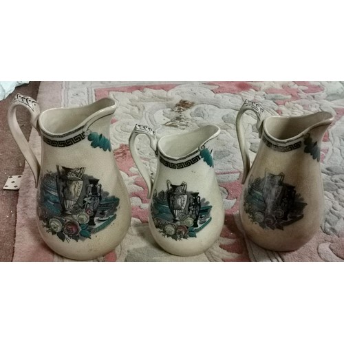 328 - Graduated trio of W. Lowe Longton jugs, largest being 22 cm tall