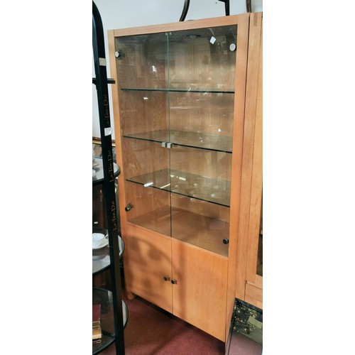 389 - 100 x 45 x 189 cm tall light oak glass shelved display cabinet