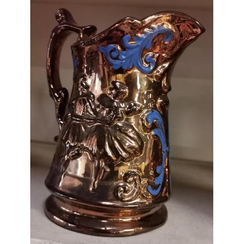 679 - 18 cm tall copper lustre glazed pitcher