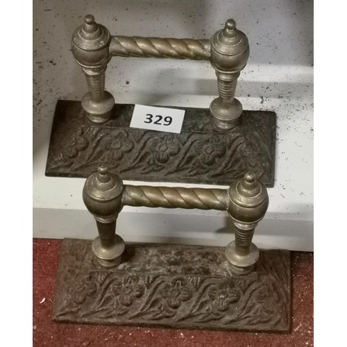 329 - Pair of old brass and hollow iron fireside tool rest