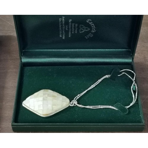 77 - Boxed 6 x 4 cm Carrick Art mother of pearl pendant on chain