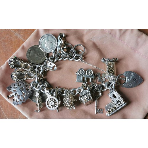 533 - Hallmarked silver charm bracelet full of assorted silver charms