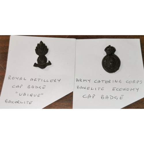 58 - Bakelite royal Artillery 'ubique' & Bakelite catering corps cap badges