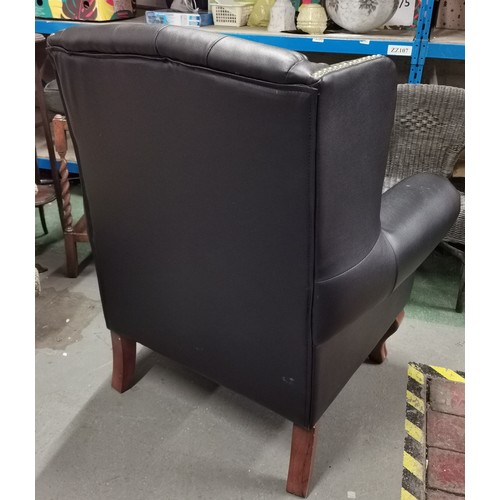 176 - Black Chesterfield style wing back armchair