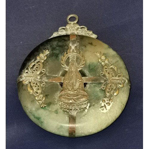 11 - Approx 5.5 cm diameter jade amulet with yellow metal  detailing