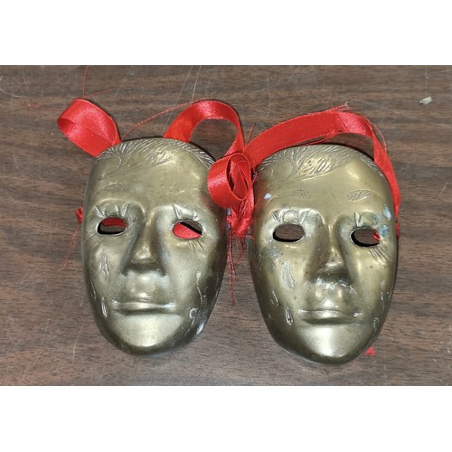 54 - Pair of 9 cm tall brass face masks