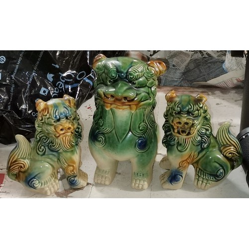 112 - Trio of ceramic Chinese lion figures, largest being 19 cm