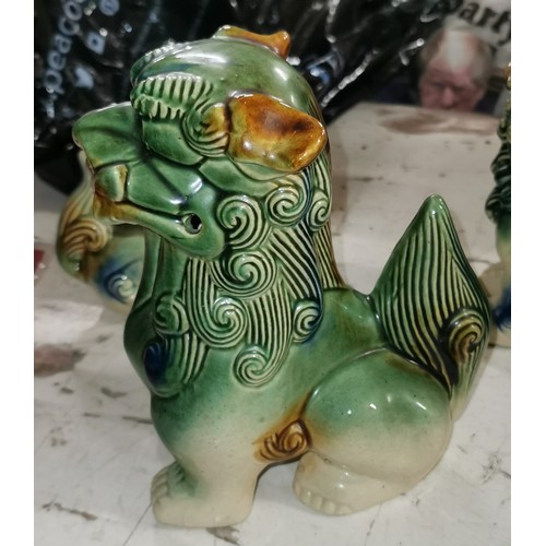 112 - Trio of ceramic Chinese lion figures, largest being 19 cm