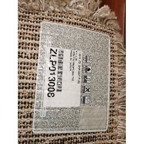 282 - As new 150 x 80 cm beige shaggy rug