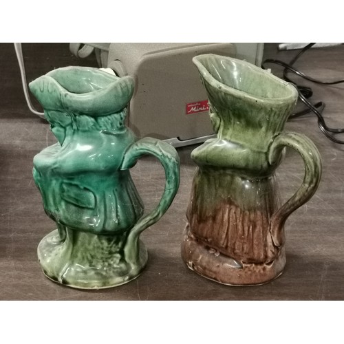 80 - Pair of approx 18 cm tall green glazed male and female Toby jugs