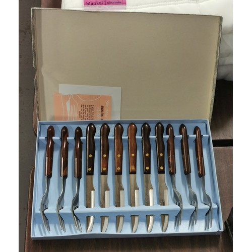 169 - Boxed and unused retro steak knife and fork set