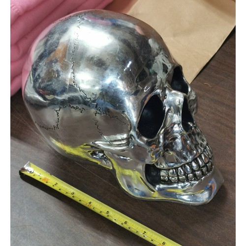 34 - 26 cm long and 20 cm tall composite silver coloured skull