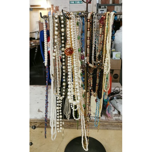 551 - Large amount of assorted dress jewellery necklaces and small metal display stand - larger stand not ... 