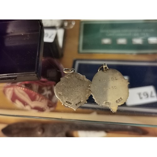 766 - 2 x hallmarked silver fobs with 1935 and 1949-50 engraved backs