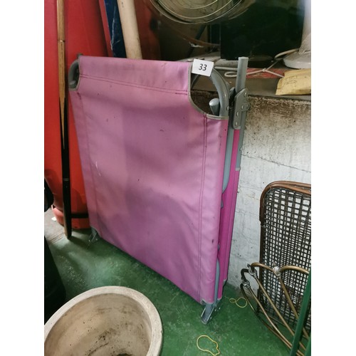 33 - Metal framed pink folding sun lounger