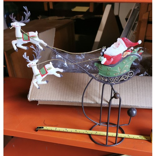 114 - Boxed metal art rocking Santa and sleigh ornament