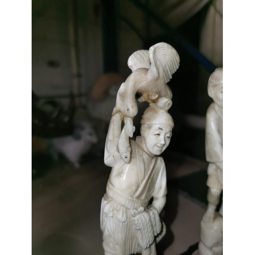 2 - Pair of carved bone look Oriental fishermen figures on wooden bases, largest 8