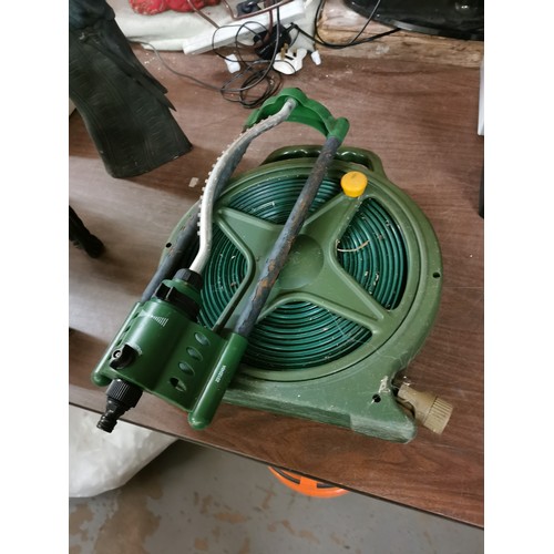 113 - Garden hose on reel and sprinkler attachment