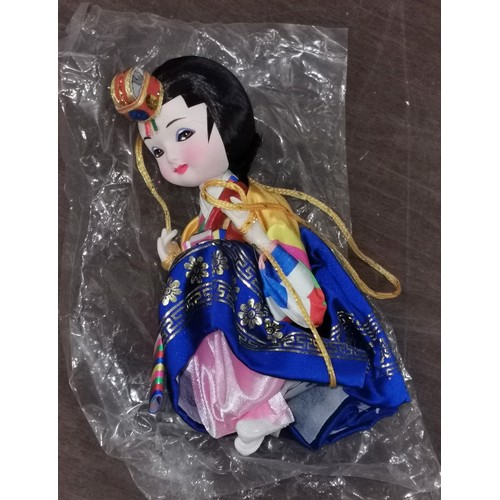 307 - Approx 16 cm tall new souvenir ware Oriental Geisha doll on swing, hanging figure