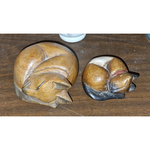 70 - graduated pair of carved wooden sleeping cats, largest approx 9 x 8 cm