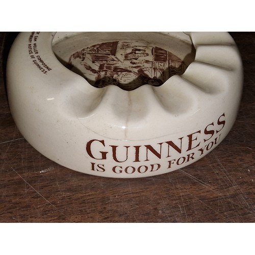 38 - Pair of vintage Guinness ashtrays being Wiltshaw & Robinson (hairline crack) and near mint Ashtead
